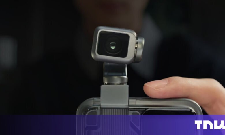 Compact camera attached to a smartphone, close-up view.