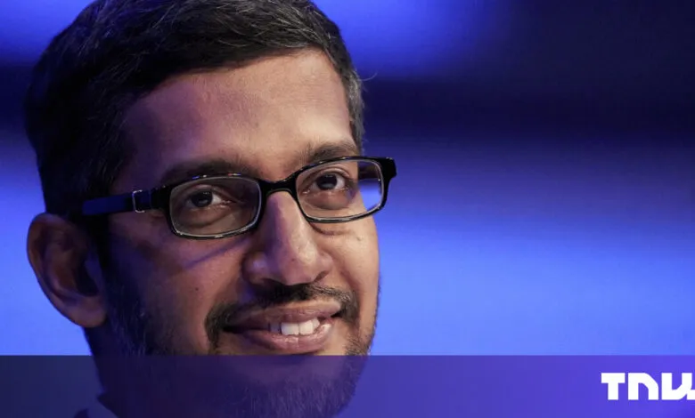 Close-up of Sundar Pichai wearing glasses against blue backdrop.