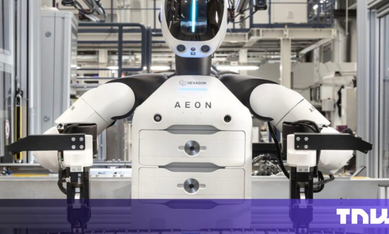 Hexagon AEON robot with white and black design in a factory setting.