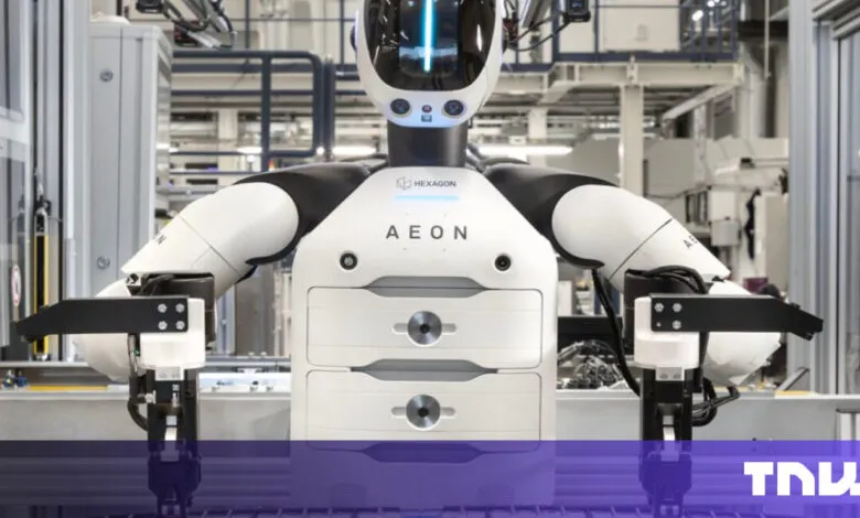 Hexagon AEON robot with white and black design in a factory setting.