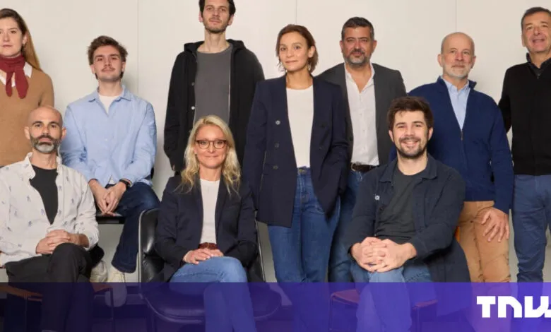 Group of ten diverse professionals pose for a company portrait.