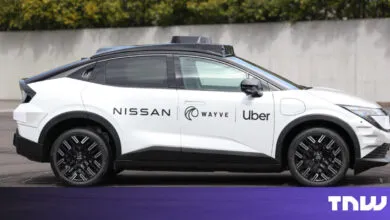 White Nissan autonomous vehicle with Wayve and Uber logos.