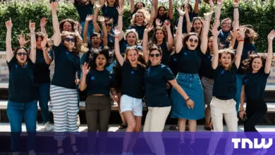 Enthusiastic group of women jumping with arms raised in celebration.