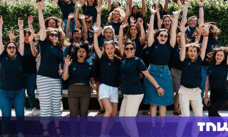 Enthusiastic group of women jumping with arms raised in celebration.