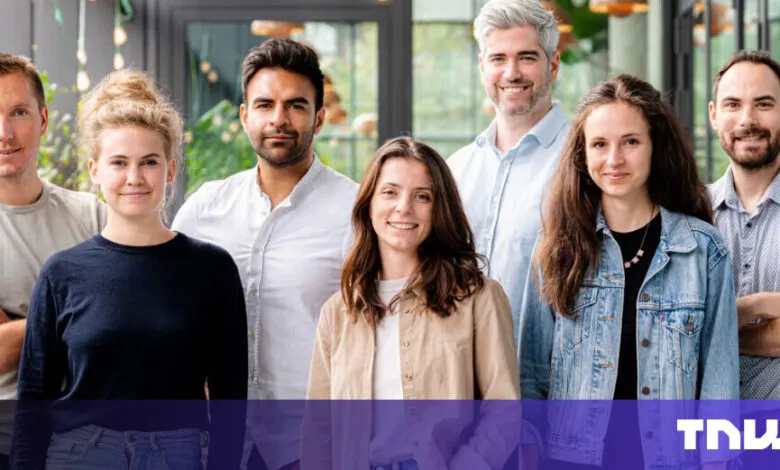 Group of seven diverse professionals smiling indoors.