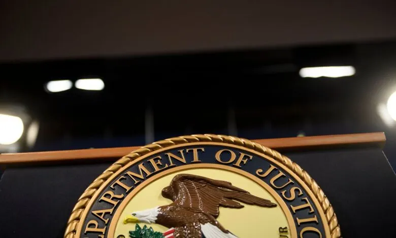Department of Justice seal on a podium, close-up view.