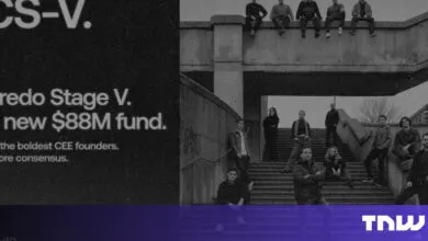 Black and white photo of a team standing on concrete stairs.