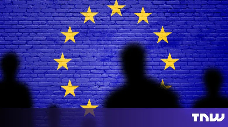 EU flag painted on brick wall with silhouetted figures in foreground.