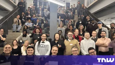 Large group of diverse people posing on stairs for a group photo.