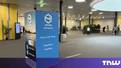 Miros Workpod advertisement in a convention hall with people walking around.