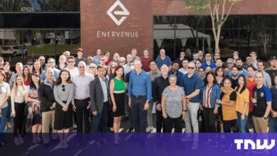 Group of EnerVenue employees posing in front of their company building.