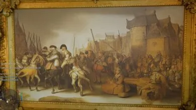 Ornate framed painting depicting a historical scene with soldiers and civilians.