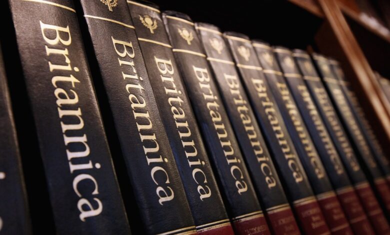 Row of Encyclopedia Britannica books on a shelf, close-up.