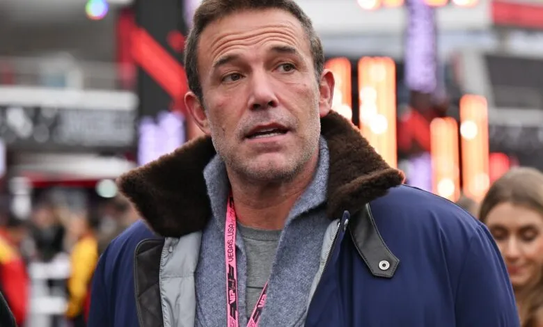 Ben Affleck at an event, wearing a blue jacket with fur collar.