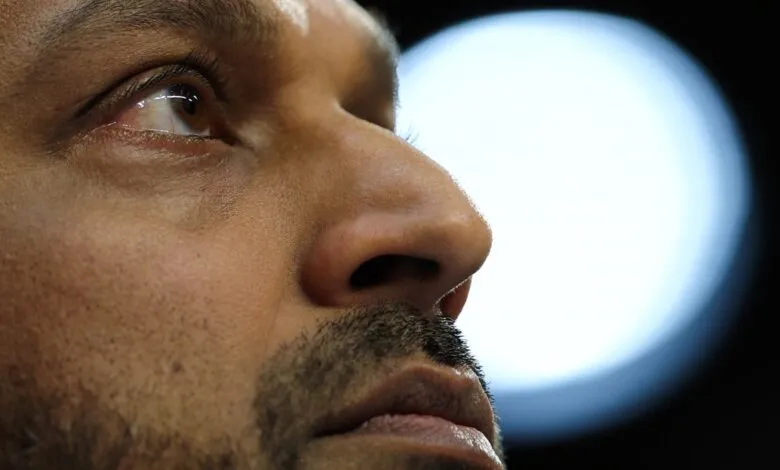 Close-up of a man's face, looking upwards with a thoughtful expression.