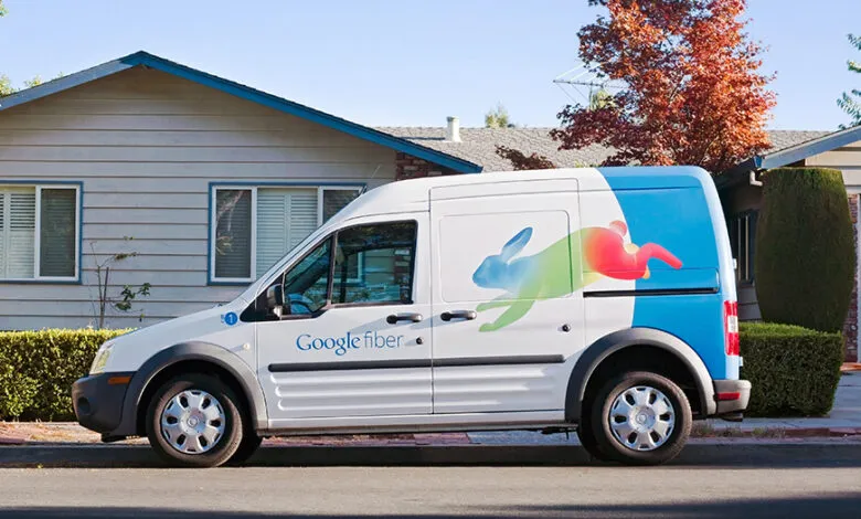 Google Fiber van parked on a residential street with a colorful rabbit logo.