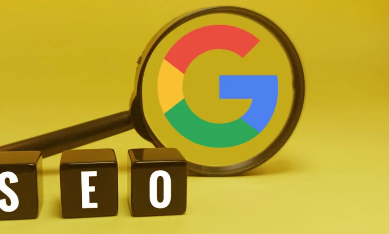 Magnifying glass over Google logo with SEO blocks on yellow background.