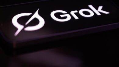 The Grok logo illuminated on a dark surface.
