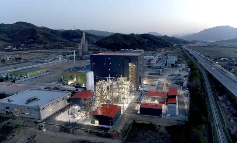 Aerial view of a large industrial factory complex in South Korea at dusk.
