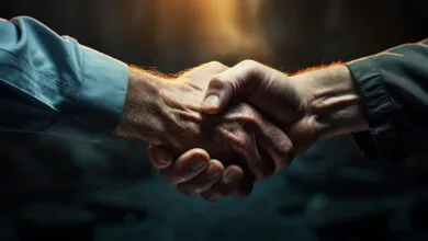 Close-up of two hands clasped in a firm handshake.