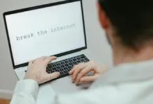 Person types 'break the internet' on laptop screen.