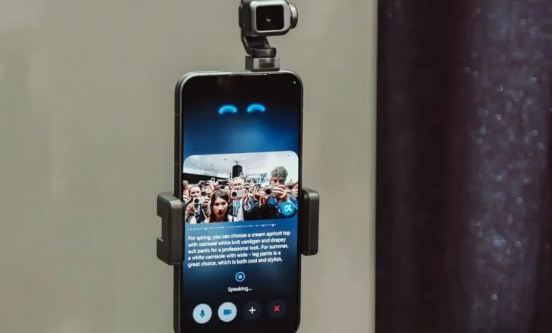 Smartphone displaying AI fashion advice with camera attached on top.