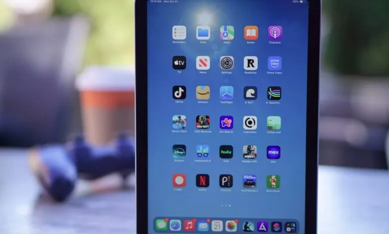 Close-up of an iPad Mini screen displaying various app icons.