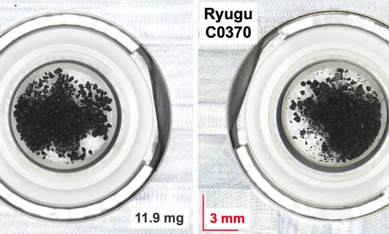 Two containers hold dark, granular samples labeled Ryugu C0370, with scale and mass indicated.