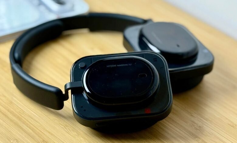 Close-up of black Nothing Headphones (1) on a wooden surface.