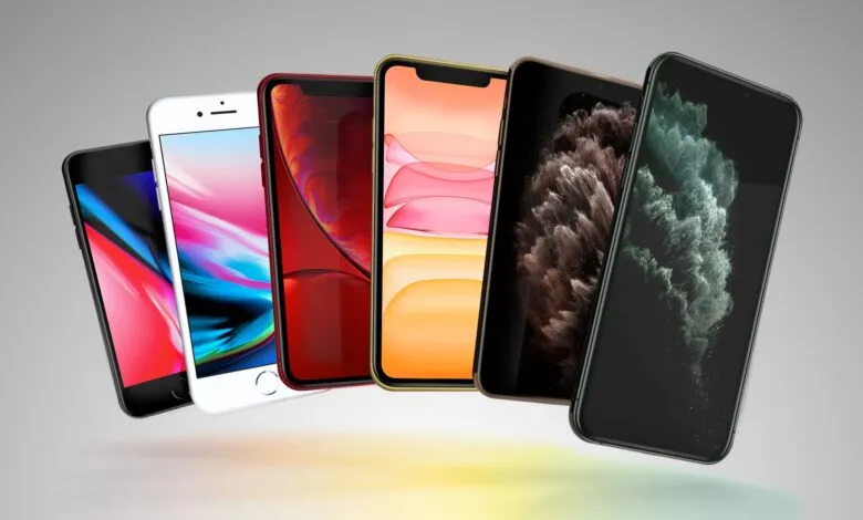 Lineup of iPhones in various colors against a gradient background.