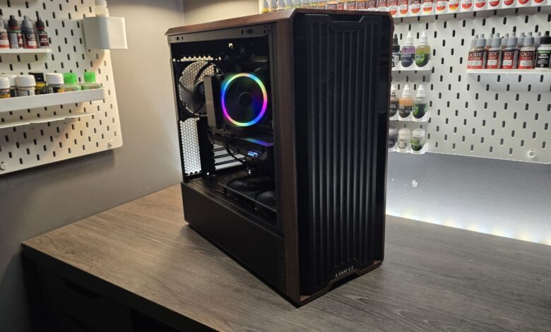 Custom PC build with wooden accents and RGB lighting on a wooden desk.