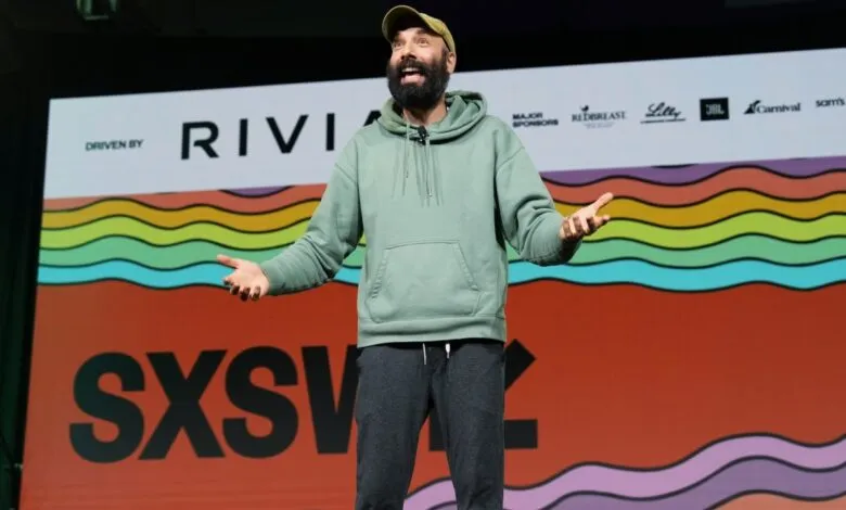 Jack Conte on stage at SXSW, gesturing with open hands.