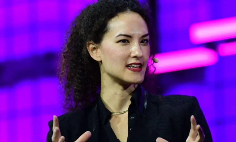 Jay Graber speaks on stage with a purple background.