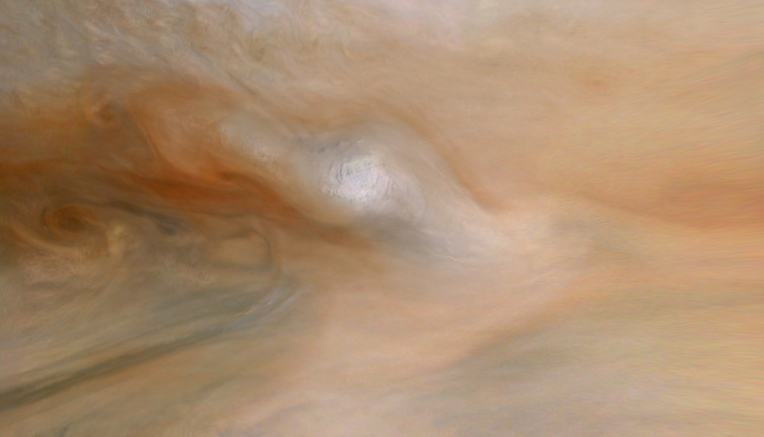 Close-up of Jupiter's swirling atmosphere with light and dark cloud bands.
