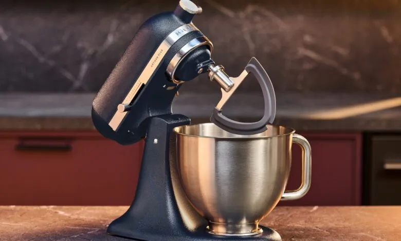Navy blue KitchenAid stand mixer with silver bowl and flex edge beater.