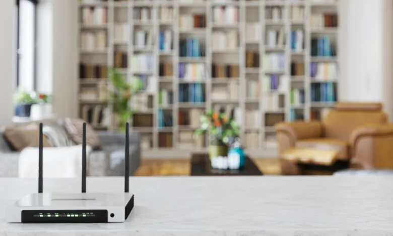 Wireless router on marble table with living room background.