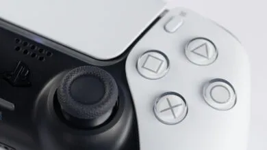 Close-up of a white and black PlayStation 5 DualSense controller.