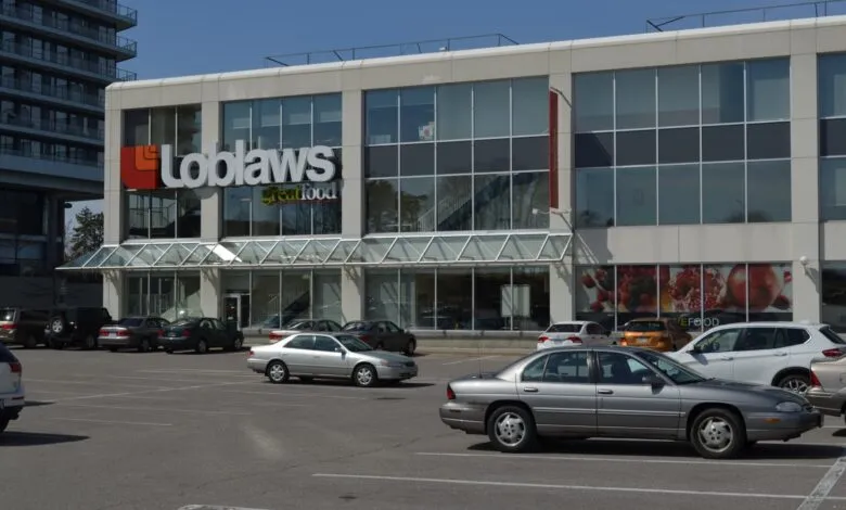 Exterior view of a Loblaws grocery store with a parking lot.