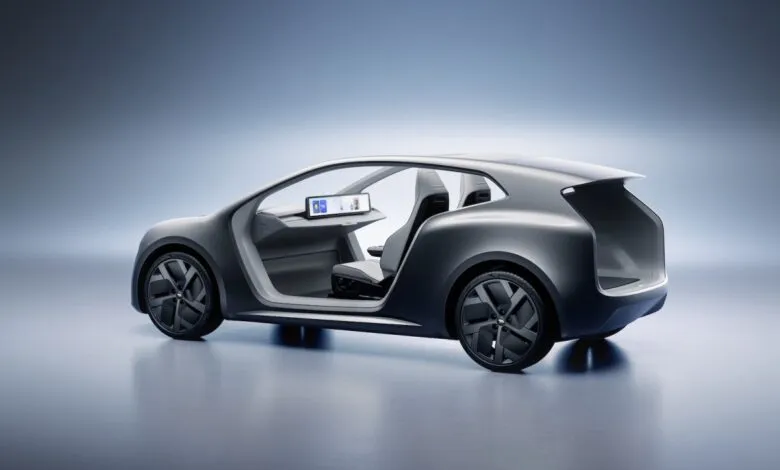 Sleek gray concept car with open doors and minimalist interior design.