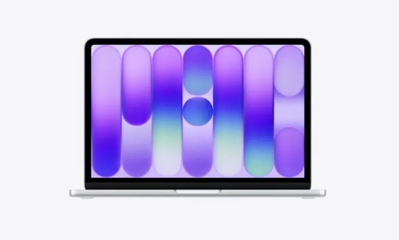 Silver MacBook Air laptop with a vibrant purple and blue abstract wallpaper.