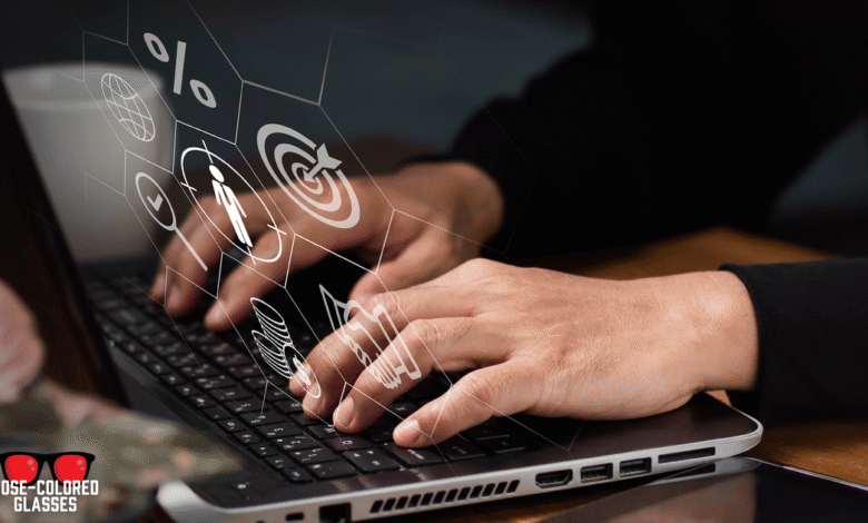 Hands type on laptop with overlaid business icons, symbolizing digital strategy.