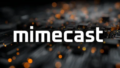 Mimecast logo in white against a blurred circuit board background with orange bokeh.