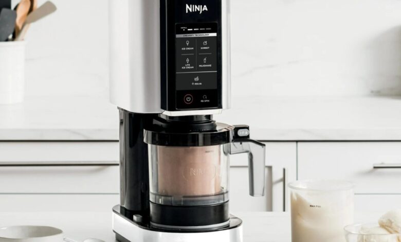 Ninja CREAMi ice cream maker on a white countertop.