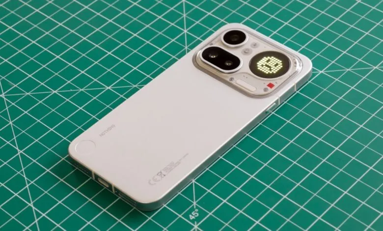 Nothing Phone with Glyph Interface on a green cutting mat.