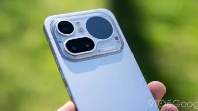 Close-up of a smartphone's camera module with three lenses and a transparent design.