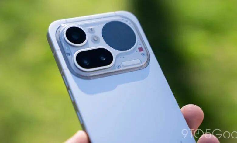 Close-up of a smartphone's camera module with three lenses and a transparent design.