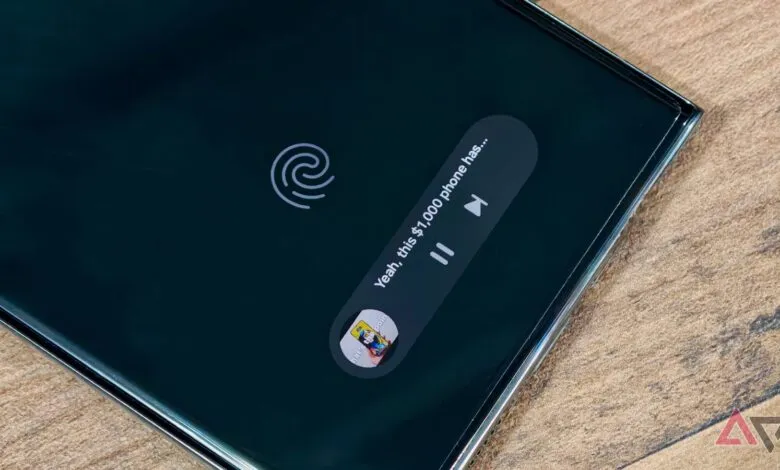Phone screen displaying 'Now Playing' with fingerprint sensor icon.