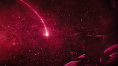 Red space scene with a bright streak resembling a shooting star.