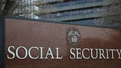 Social Security Administration sign with logo and building in background.