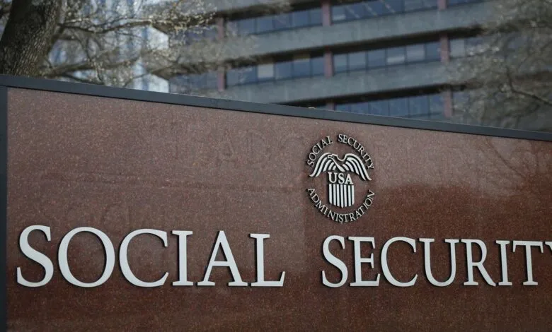 Social Security Administration sign with logo and building in background.